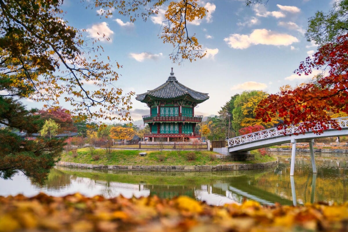 Hyangwonjeong Pavilion at Gyeongbokgung Palace surrounded by autumn foliage