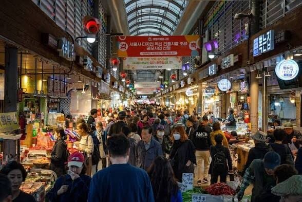 Crowded traditional market in Korea with food and produce stalls