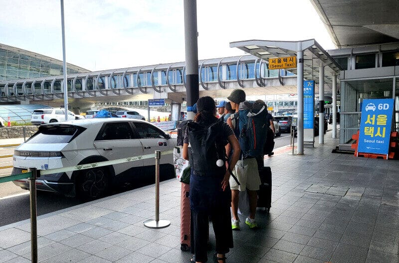 Travelers waiting at the Seoul taxi stand outside Incheon Airport Terminal 1