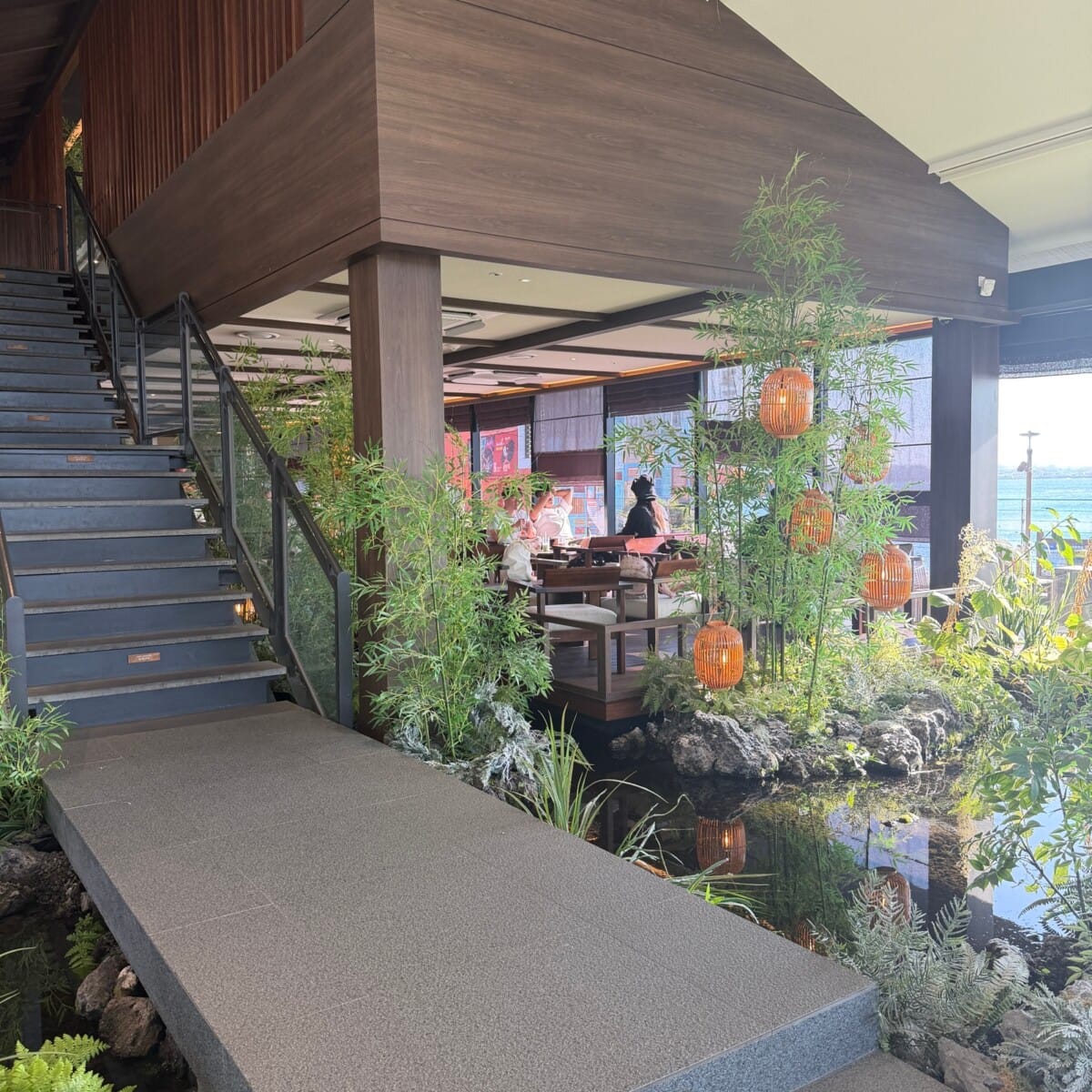 Wood, plants and water features inside Cheongsudang Aewol cafe on Jeju Island