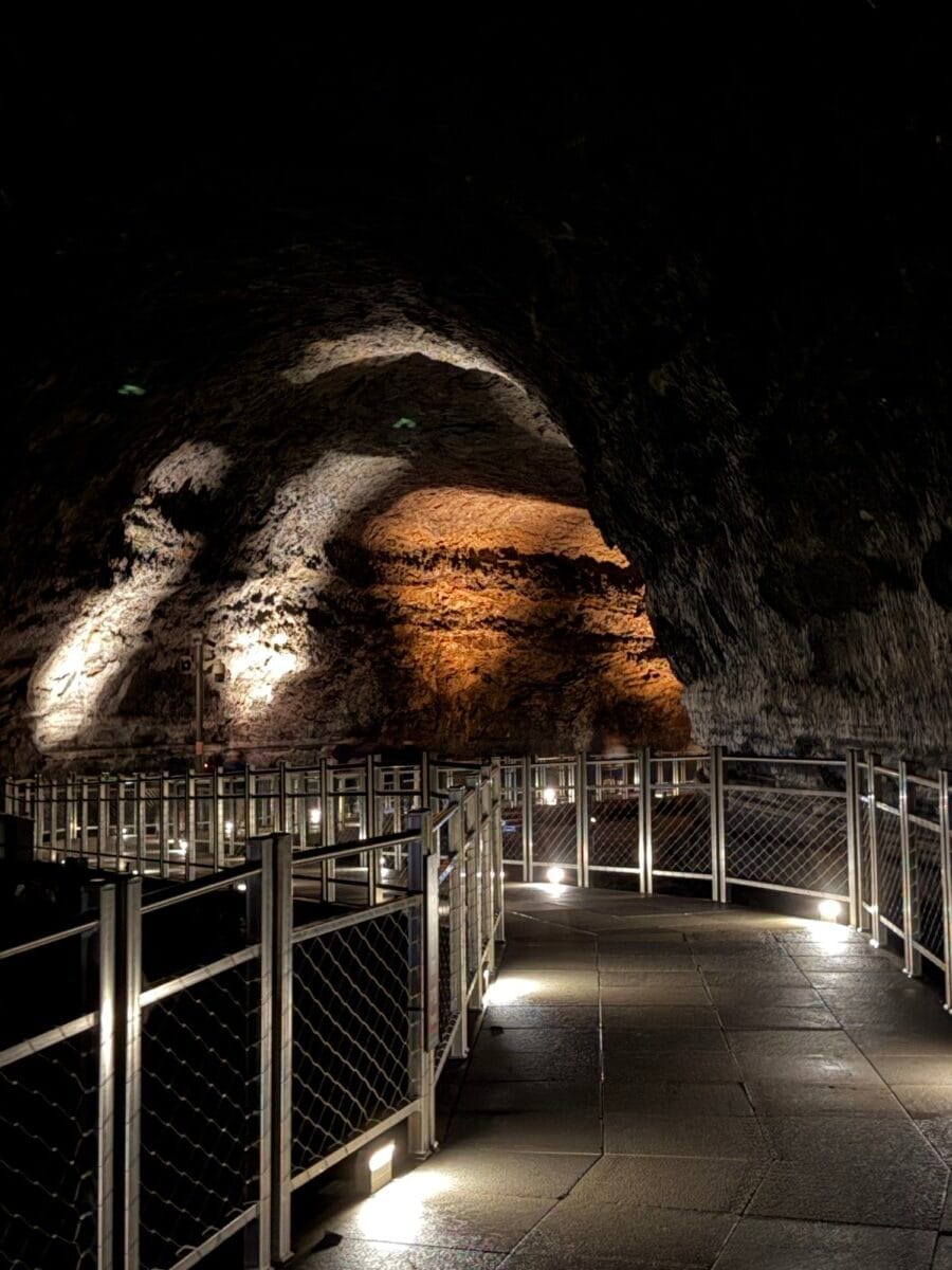 Dark lava formations beside the visitor walkway inside Manjanggul